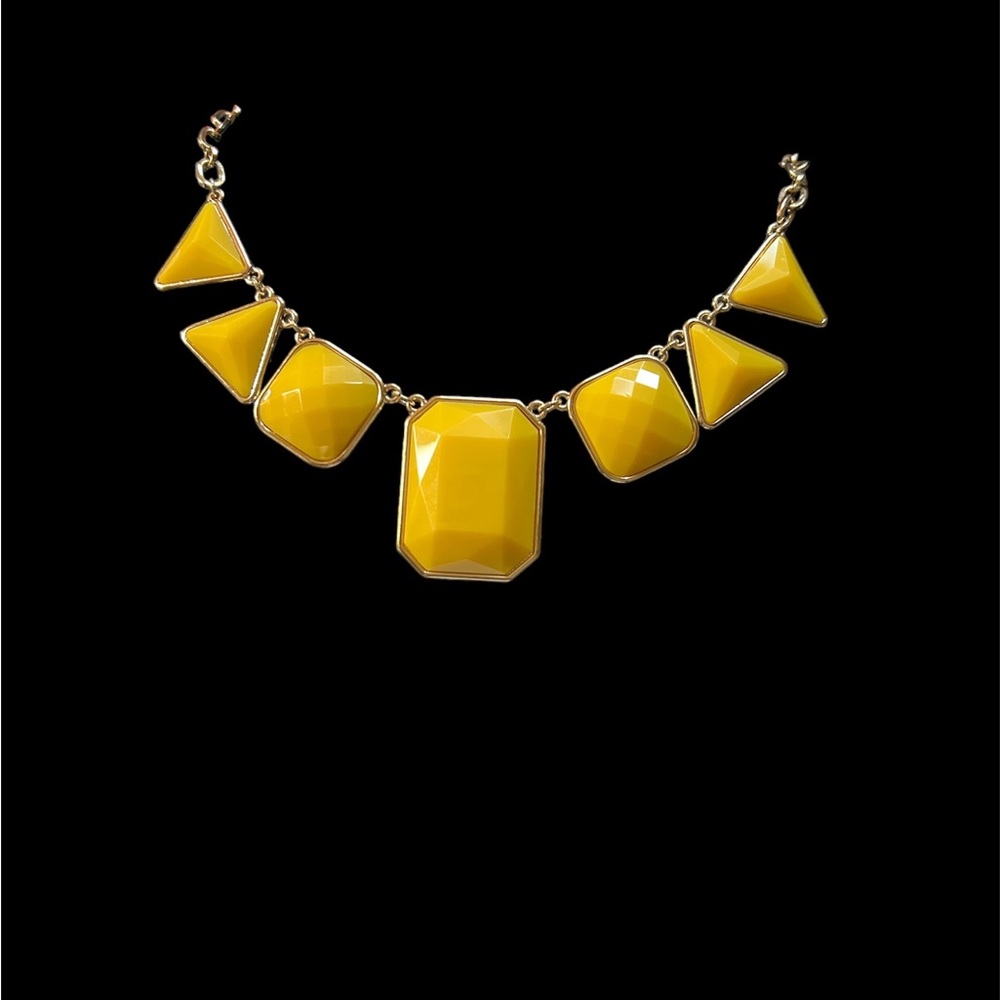 Yellow stones set in gold toned metal